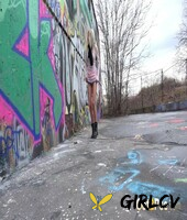 blonde girl claudia macc pees on pavement near a wall of graffiti141373