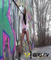blonde girl claudia macc pees on pavement near a wall of graffiti141384