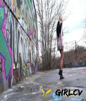 blonde girl claudia macc pees on pavement near a wall of graffiti141387