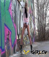 blonde girl claudia macc pees on pavement near a wall of graffiti141375