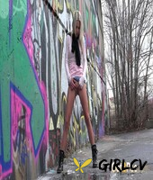 blonde girl claudia macc pees on pavement near a wall of graffiti141381