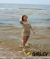 tall teen mina hangs wet clothes to dry while posing nude on a beach86798