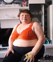 naughty chubby granny hortensia plays with her big tits while undressing