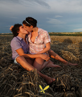 young girl and her boyfriend undress each other for sex in a farmers field