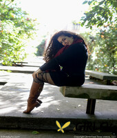 lovely chubby doll with curly hair lili toying herself in nature