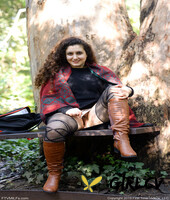 lovely chubby doll with curly hair lili toying herself in nature