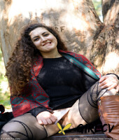 lovely chubby doll with curly hair lili toying herself in nature