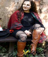 lovely chubby doll with curly hair lili toying herself in nature