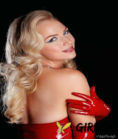 glamorous blonde ancilla tilia takes off her red latex dress and poses topless