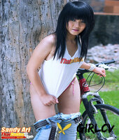 nice thai girl sandy ari partially disrobes while playing with a vibrator131453