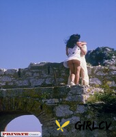 brunette female gets banged by two guys at once among ruins of stone building