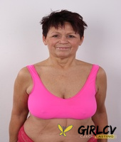 older amateur strips down to her birthday suit in front of a white wall