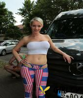 short-haired german blonde strips and poses in the back of a van235269