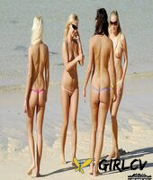 four girls model revealing bikini bottoms while topless on a sandy beach159148