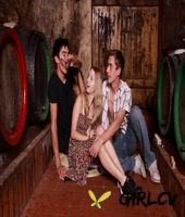 young blonde has sex with a couple of boys while they drink wine in a cellar