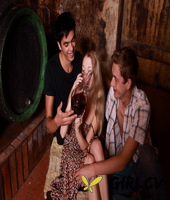 young blonde has sex with a couple of boys while they drink wine in a cellar