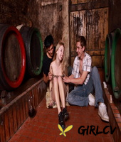 young blonde has sex with a couple of boys while they drink wine in a cellar