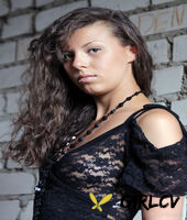 brunette teen salsa gets naked on a stone wall near a body of water