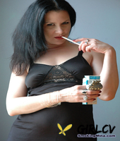 fair skinned female puffs on a smoke while working clear of black lingerie135147