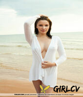 brunette teen flaunts her nice melons on a beach blanket beside the ocean115459